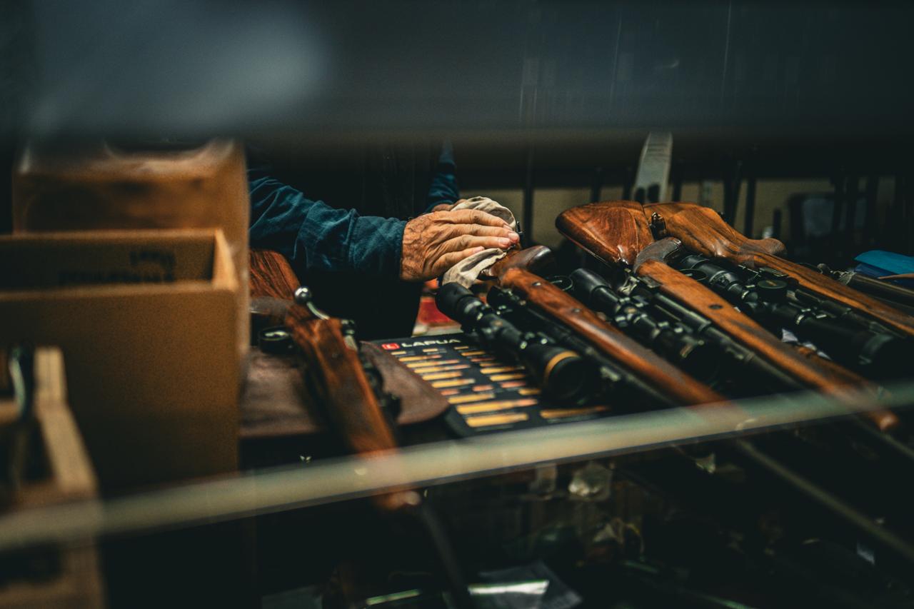 Rifles with scopes laid out on the counter at Hugo van Zyl Sports, Paarl